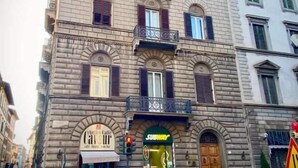 A multi-story building with a Subway entrance, a visible storefront, and a street-level entrance. - San Giuliano Inn - Adults Only (Florence)