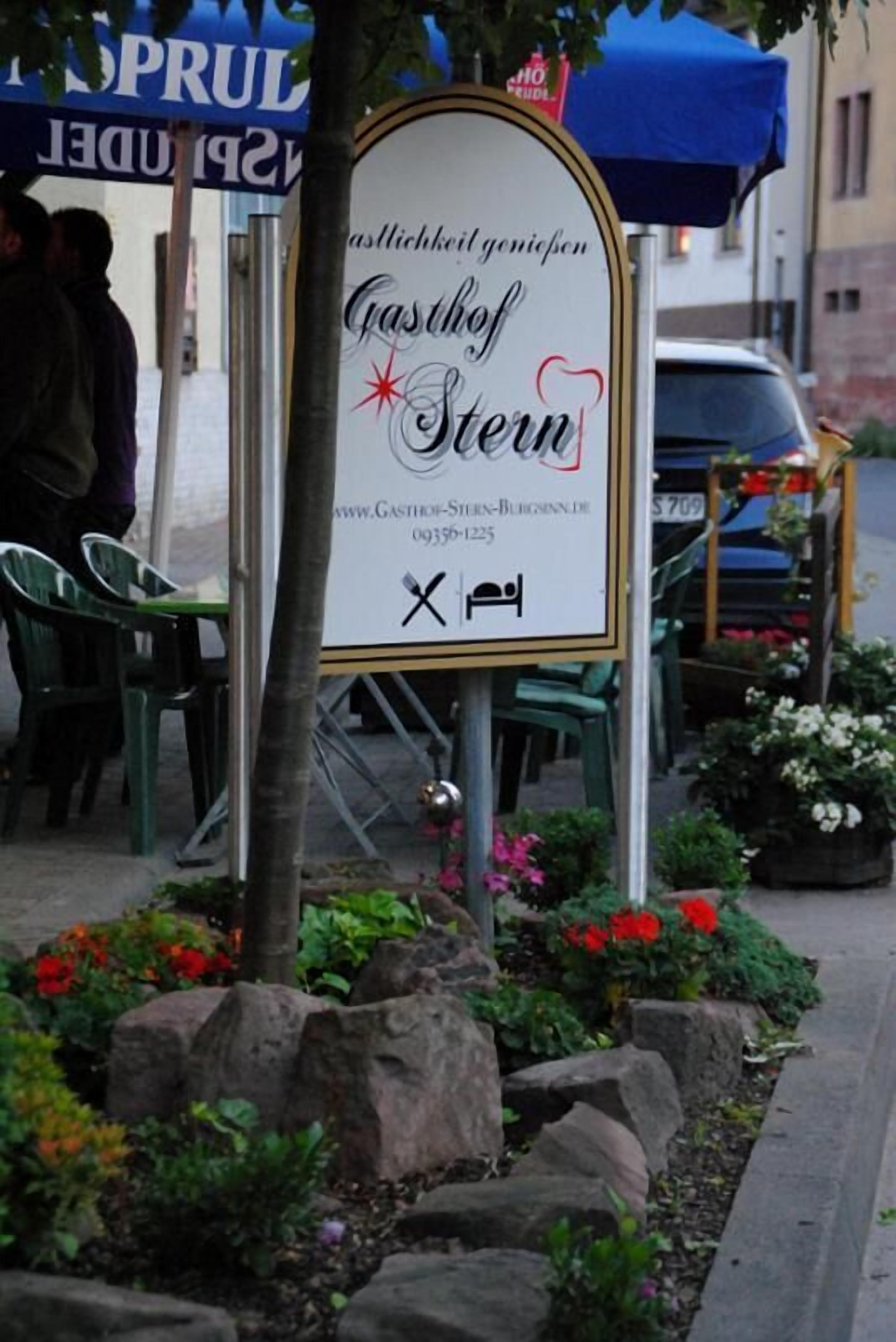 Schild für ein Restaurant namens 'Gasthof Stern', mit Webseite und Telefonnummer.