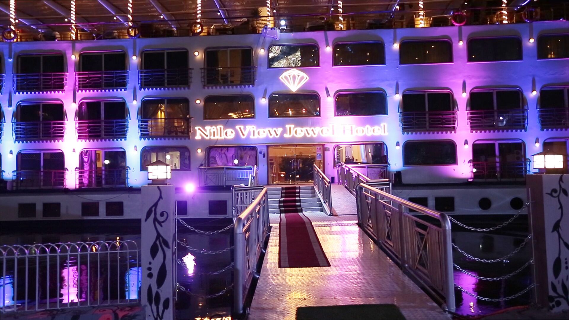 A multi-story building with balconies and a central entrance.