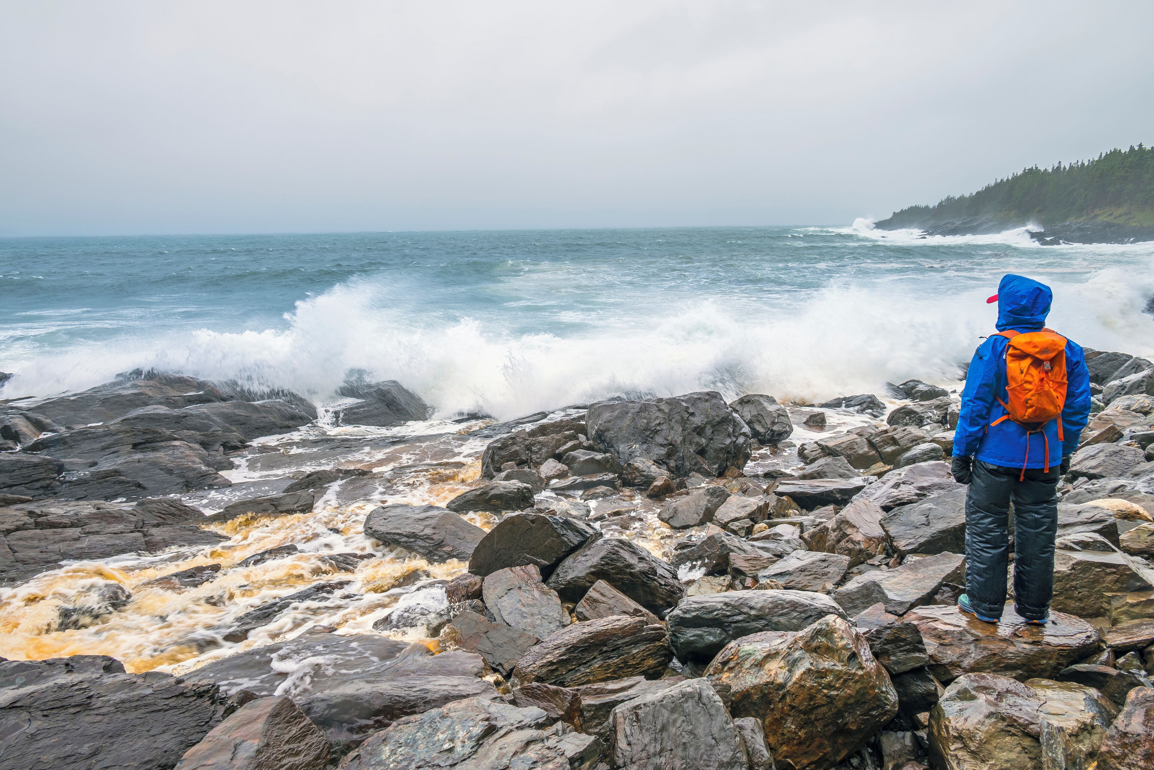 A rocky shoreline with waves crashing against the rocks.