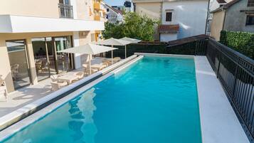 Seasonal outdoor pool, open 10:00 AM to 8:00 PM, pool umbrellas