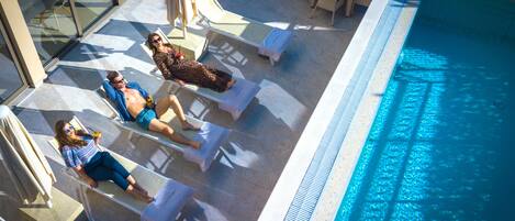 Seasonal outdoor pool, open 10:00 AM to 8:00 PM, pool umbrellas