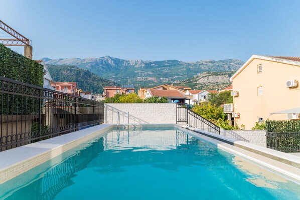 Seasonal outdoor pool, open 10:00 AM to 8:00 PM, pool umbrellas