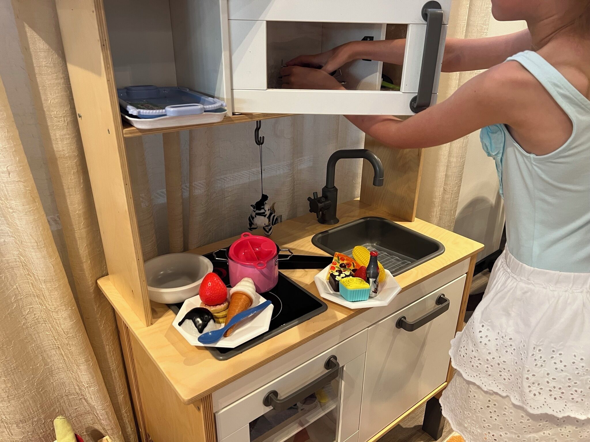 A kitchenette with a sink, a small countertop, and a cabinet with a drawer.