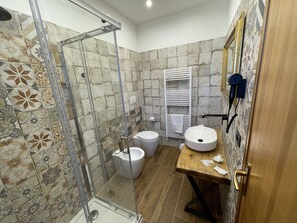 Enjoy a refreshing shower in the bathroom, featuring a shower enclosure, toilet, and vanity with sink.