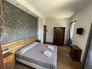 Restful retreat with a large bed, wooden headboard, and ample storage.
