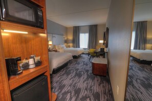 A hotel room with two beds, a desk, a chair, a microwave, a coffee maker, and a small refrigerator. - Fairfield Inn & Suites by Marriott Gatlinburg Downtown (Gatlinburg)