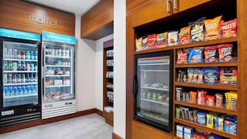 A vending area with snack and drink options, including brands like Smartfood and Sun Chips.