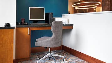 A modern office space with a desk, computer, and office chair.