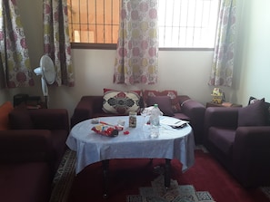 Deluxe Quadruple Room | Living area | 55-inch flat-screen TV with satellite channels, TV