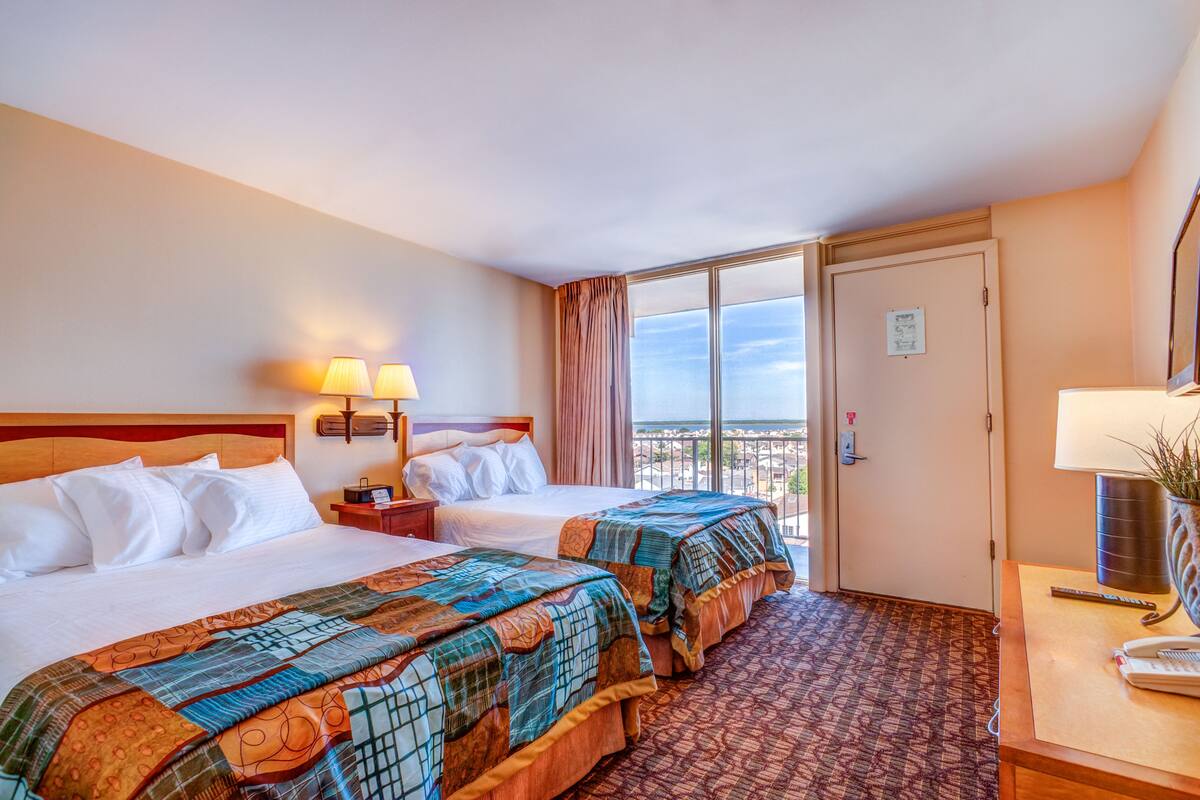 deluxe room, multiple beds, kitchenette, ocean view | in-room safe, desk, iron/ironing board, free wifi