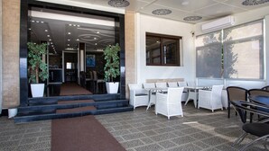 A hotel lobby with a modern design, featuring a reception desk, seating area, and large windows. - Hotel Jibal Chaouen (Chefchaouen)