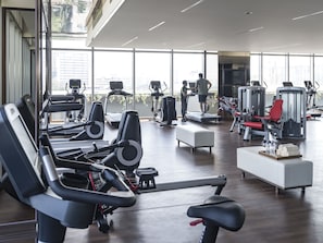A modern gym with various exercise equipment, large windows, and a clean, spacious layout. - Shangri-La Colombo (Colombo)