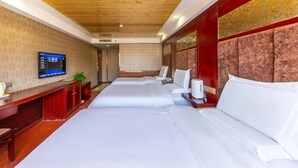 A hotel room with a wooden ceiling, a television on the wall, and two beds with white linens. - Greentree Inn Lanzhou Train Station Road East Business Hotel (Lanzhou)