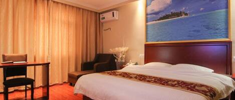 A hotel room with a large bed, a desk with a chair, a small table, and a painting of a beach scene.