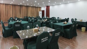 A conference room with green chairs and tables, equipped with nameplates and a podium. - GreenTree Inn JiangSu ZHenjiang Jurong Yalong Hotel (Zhenjiang)