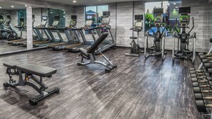 A gym with treadmills, elliptical machines, and a bench. - Fairfield Inn & Suites by Marriott Ontario Rancho Cucamonga (Rancho Cucamonga)