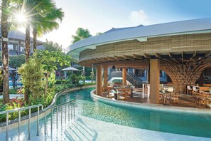 A poolside area with a covered seating area, a pool, and surrounding greenery. - Marriott’s Bali Nusa Dua Gardens (Nusa Dua)