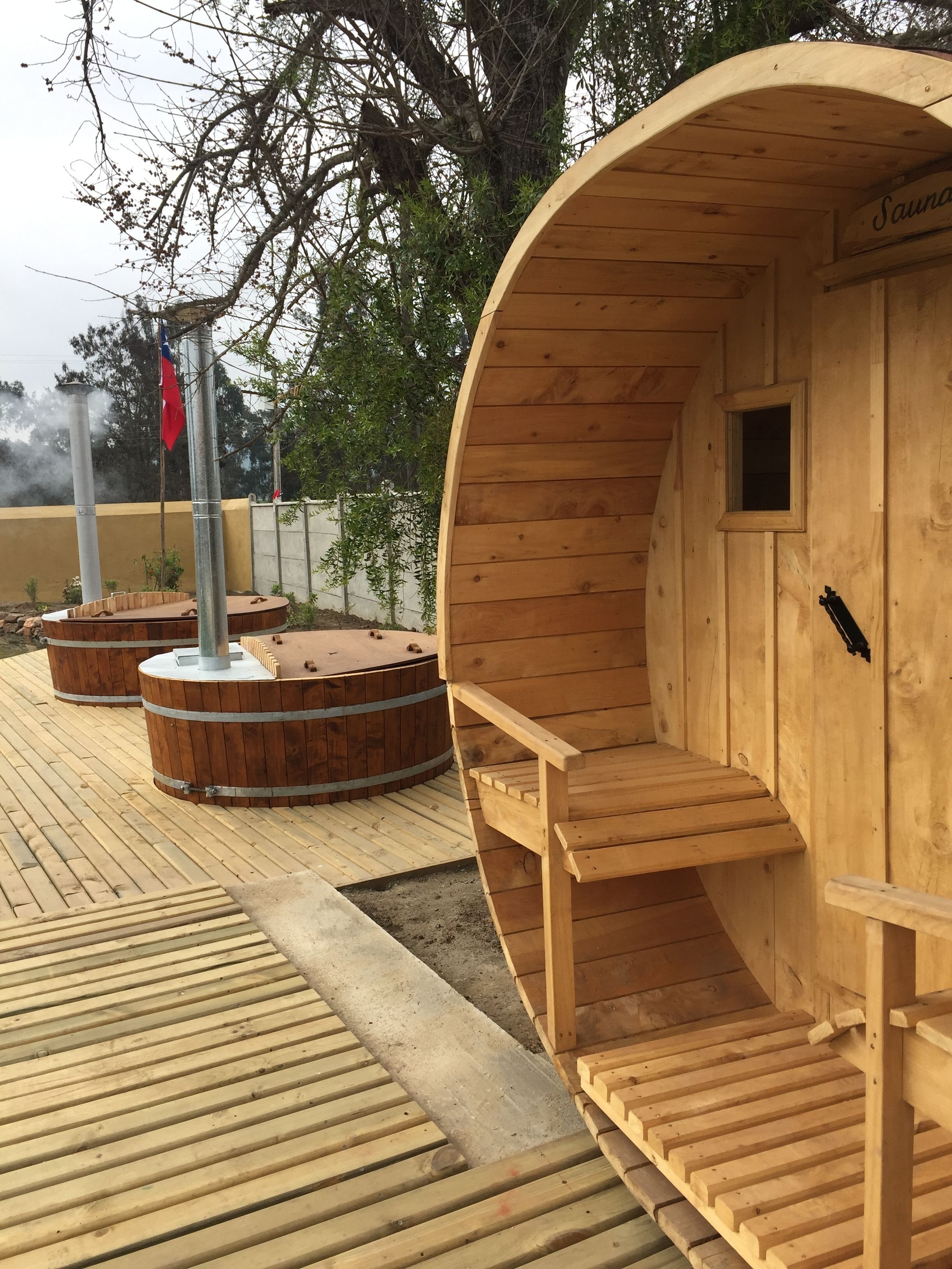 A sauna with a wooden exterior, a small window, and a sign that reads "Sauna".