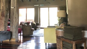 A rustic interior with wooden beams, large barrels, and a seating area with a yellow table and chairs. - Hotel Boutique Lagunillas Casablanca  (Casablanca)