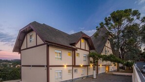 A traditional European-style building with multiple windows and a well-lit entrance. - Pousada Itália Moderna (Campos do Jordão)
