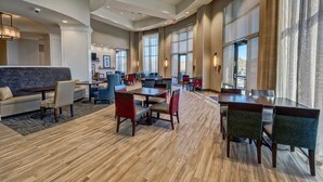 A spacious hotel lobby with a mix of seating options including sofas, chairs, and tables. - Hampton Inn & Suites Franklin Berry Farms (Franklin)