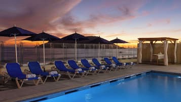 Relax by the pool with lounge chairs and umbrellas, or dine at the pavilion.