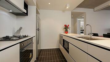 Apartment, 1 Queen Bed | Private kitchen | Fridge, microwave, stovetop, dishwasher