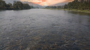 A river with a forested landscape and a colorful sky. - Clearwater 12 Motel (Kamiah)