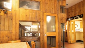 A hotel office with wooden walls and a visible reception area. - Helgeson Place Hotel & Suites (Orofino)