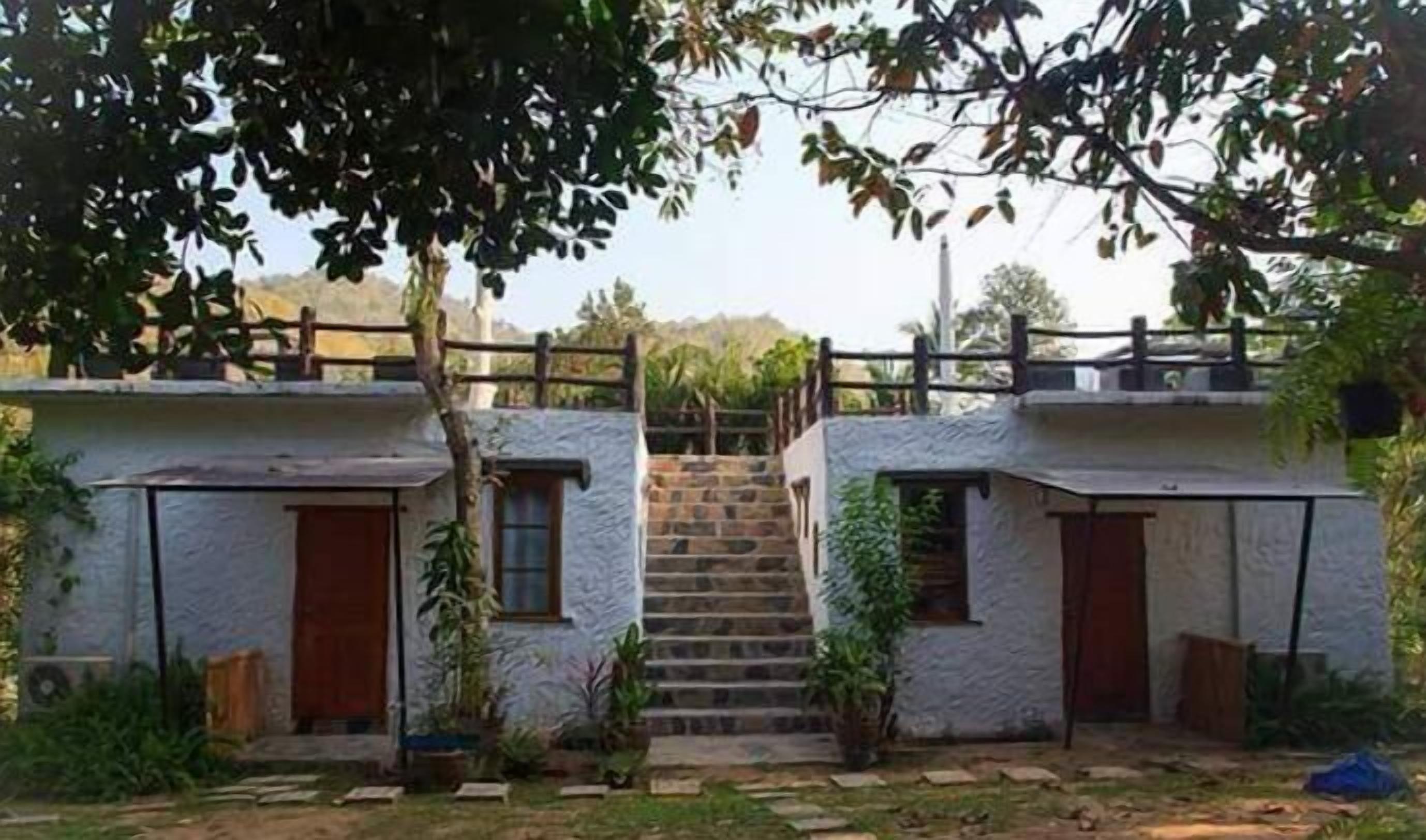 A two-story building with a central staircase leading to the upper floor.
