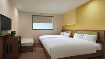 A hotel room with two beds, a flat-screen TV, a coffee maker, and a window with blinds.