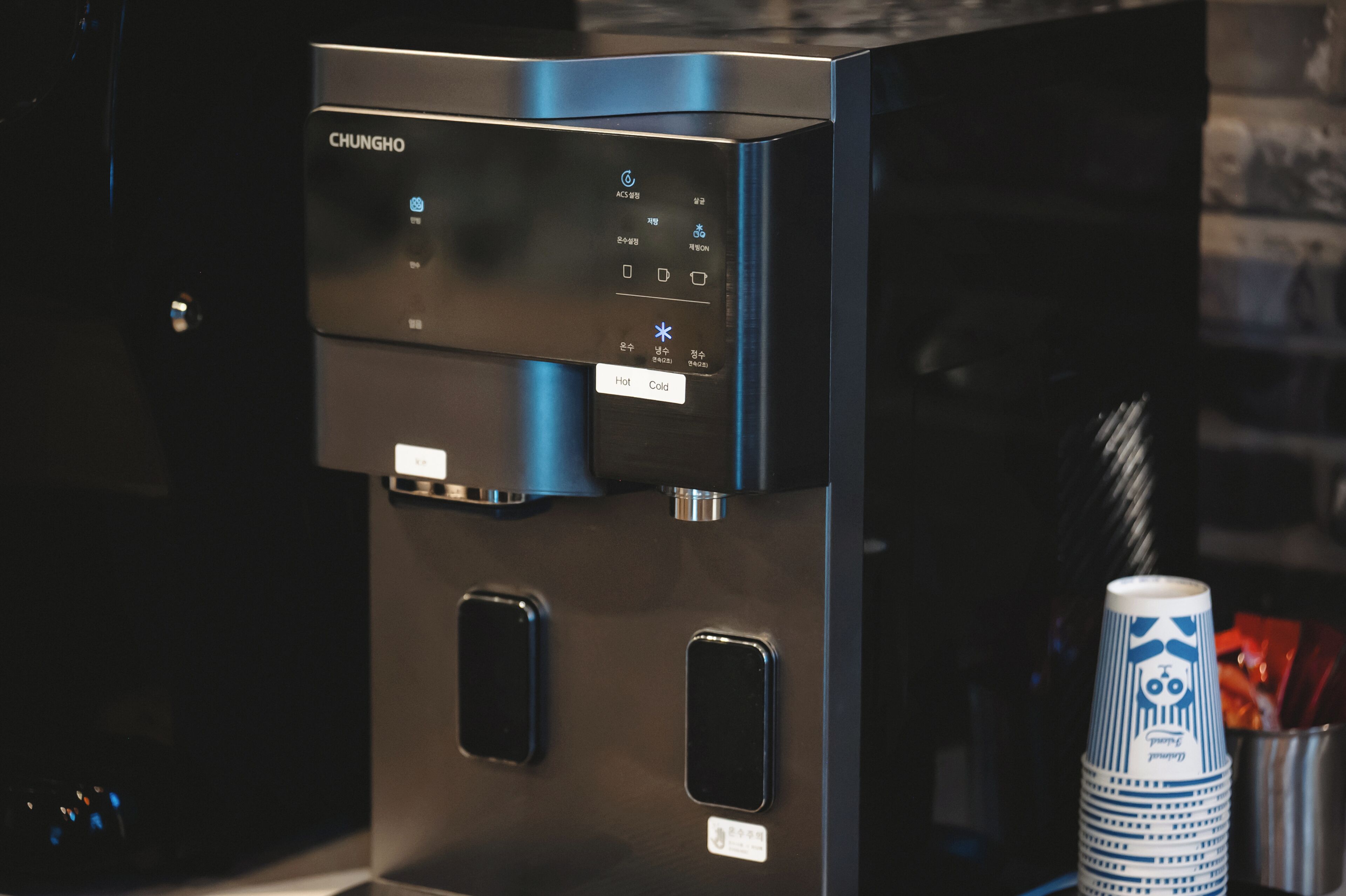 A stainless steel coffee machine with a digital display and buttons, placed on a kitchen counter.