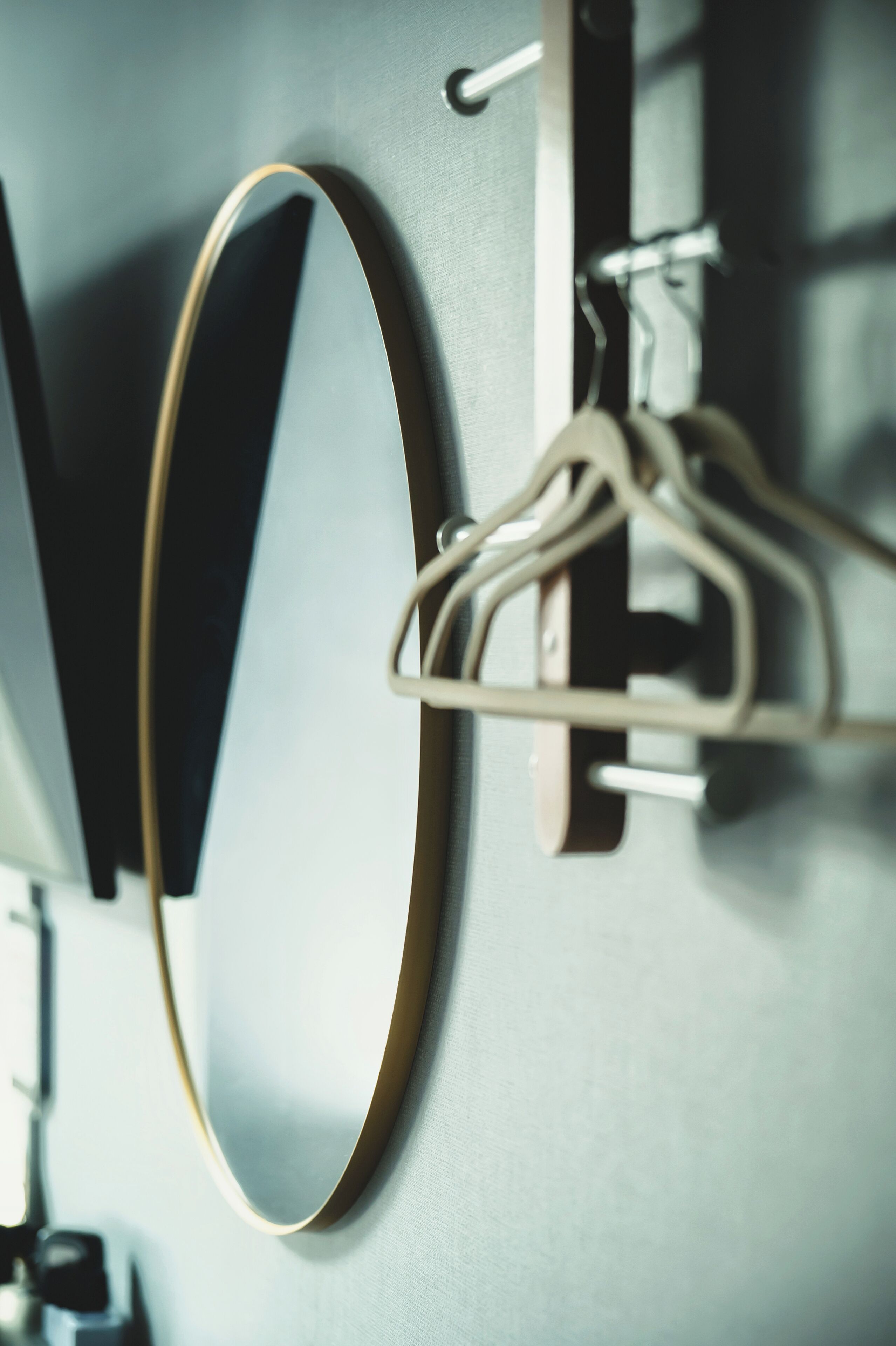 A bathroom with a mirror, a towel rack, and a towel hanging on the rack.