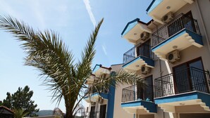 A multi-story building with balconies and air conditioning units. - Atlas Otel (Fethiye)