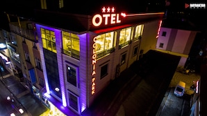 A hotel with a neon sign, balconies, and a visible entrance. - Colonia Park Hotel (Sebinkarahisar)