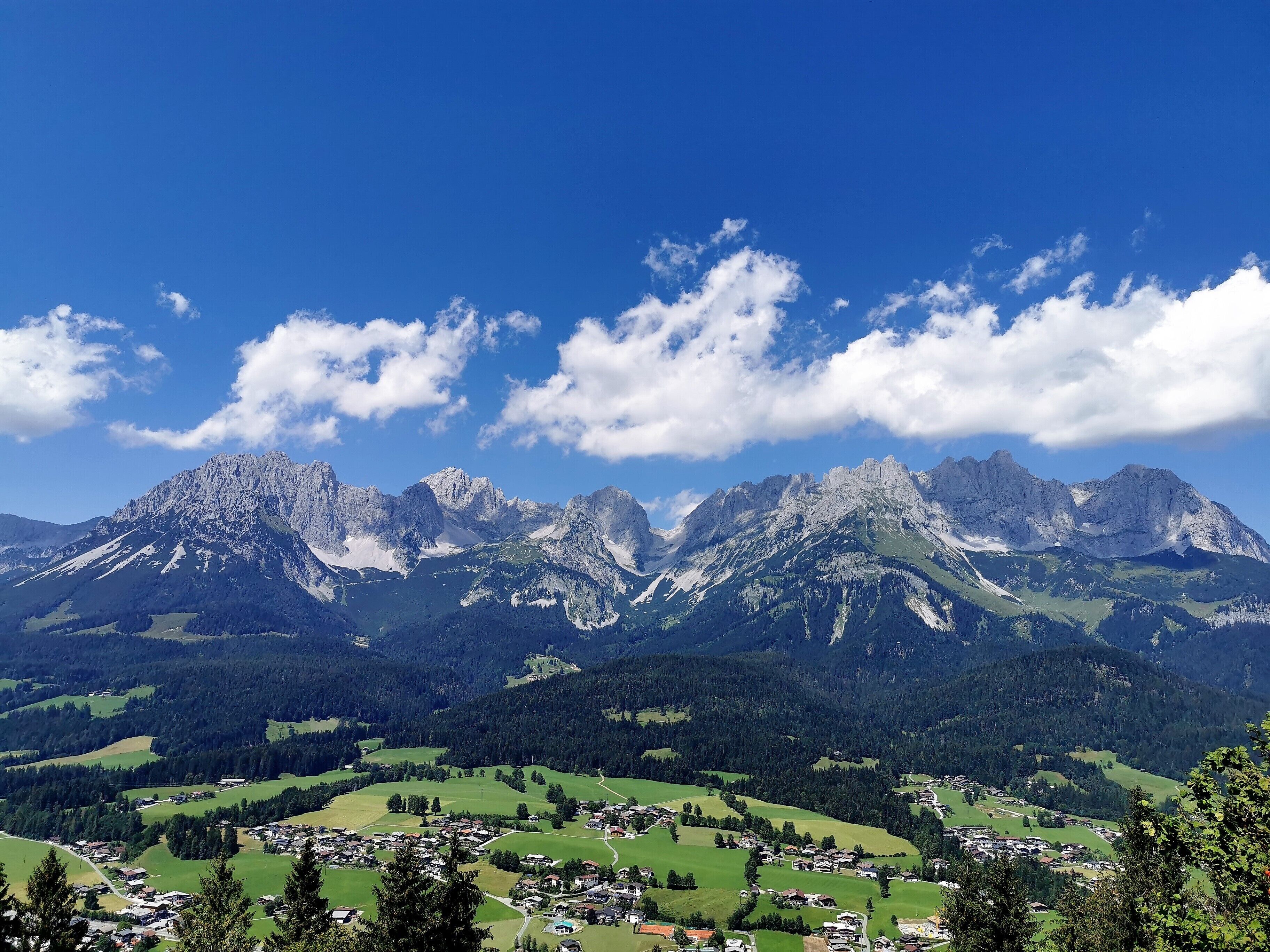 A mountainous landscape with a town in the valley.