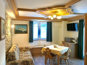 Deluxe Apartment, 2 Bedrooms, Mountain View | Living area | 42-inch flat-screen TV with satellite channels, TV