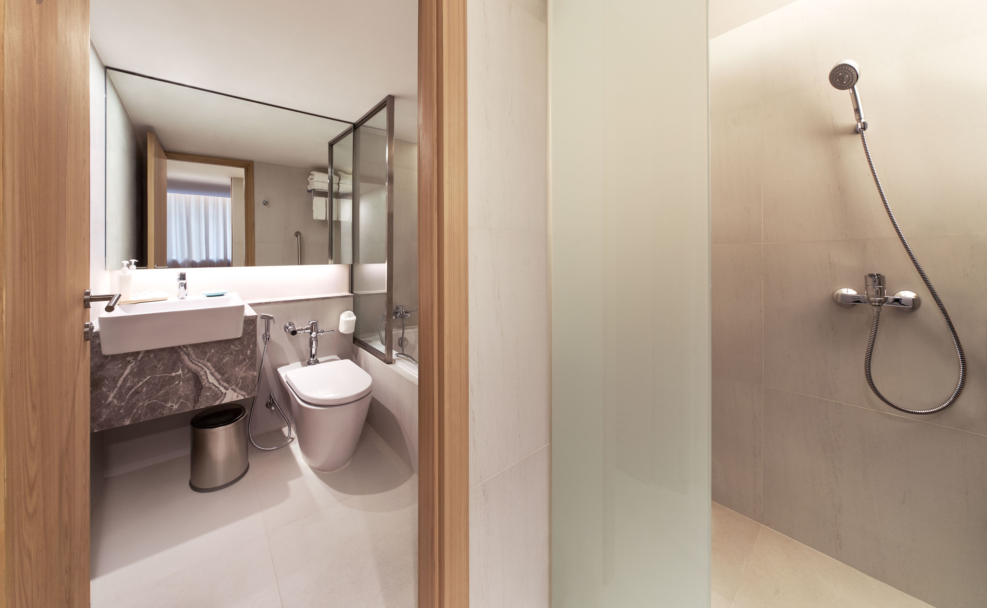 king room with two king beds | bathroom | free toiletries, hair dryer, slippers, towels