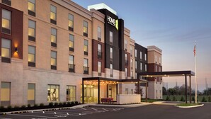 A multi-story hotel with a prominent 'HOME 2' sign, a covered entrance, and a parking lot. - Home2 Suites Florence/Cincinnati Airport South, KY (Florence)