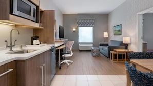 A modern kitchen with a microwave, sink, and dining area. - Home2 Suites Florence/Cincinnati Airport South, KY (Florence)