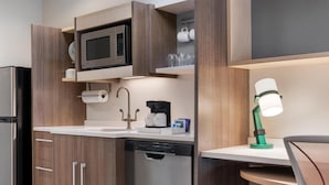 A compact kitchen with a microwave, coffee maker, and dishwasher. - Home2 Suites Florence/Cincinnati Airport South, KY (Florence)