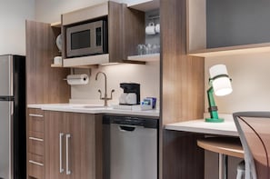 A compact kitchen with a microwave, coffee maker, and dishwasher. - Home2 Suites Florence/Cincinnati Airport South, KY (Florence)