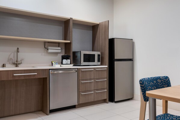 A compact kitchen with a microwave, refrigerator, and dishwasher. - Home2 Suites Florence/Cincinnati Airport South, KY (Florence)