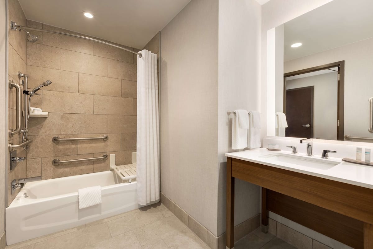 designer toiletries, hair dryer, towels, soap