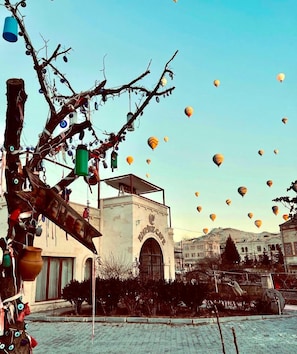 A building with a large arched entrance and a sign reading 'Empire Gate.' - Empire Cave Hotel (Nevsehir)