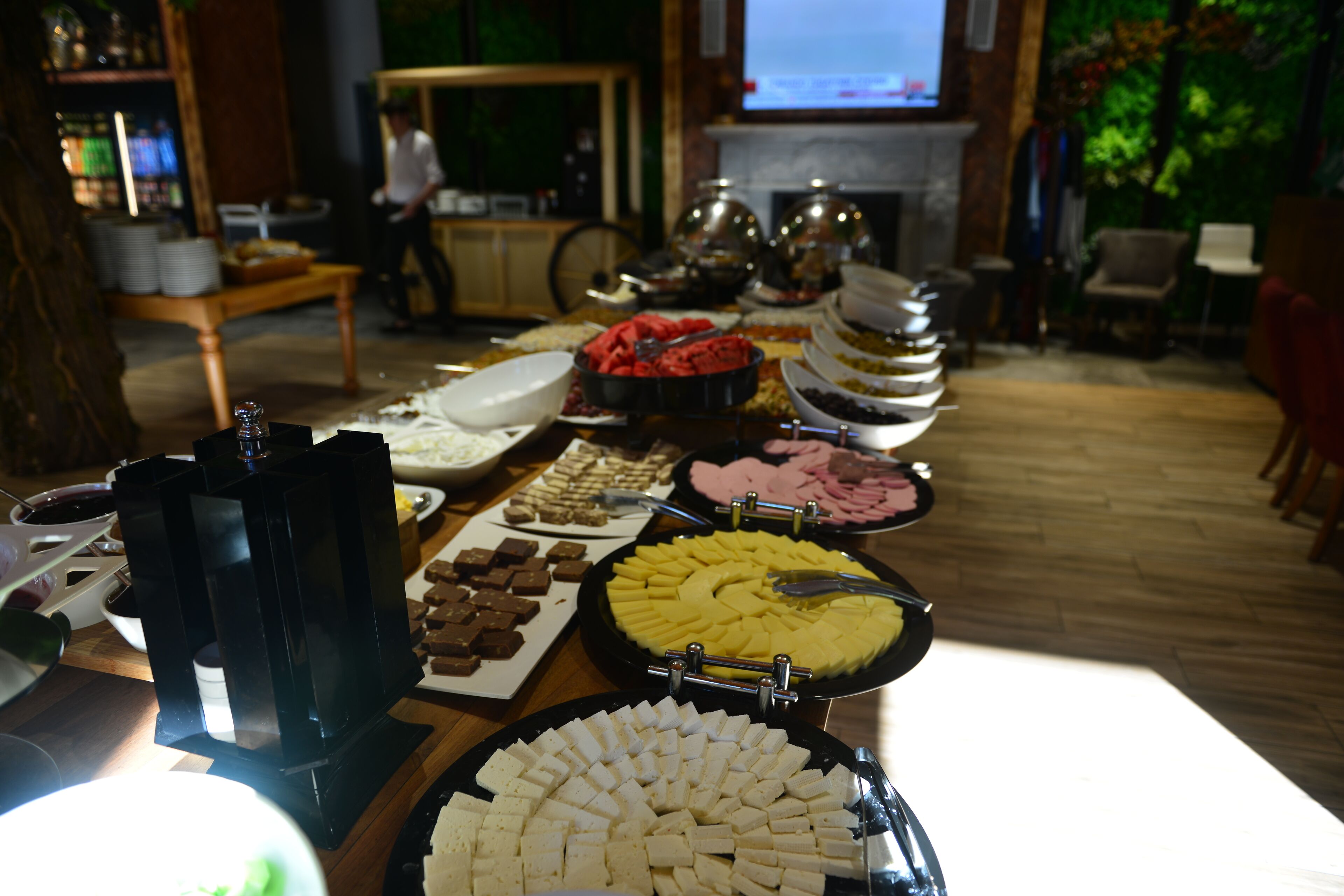 A buffet table with various food items.