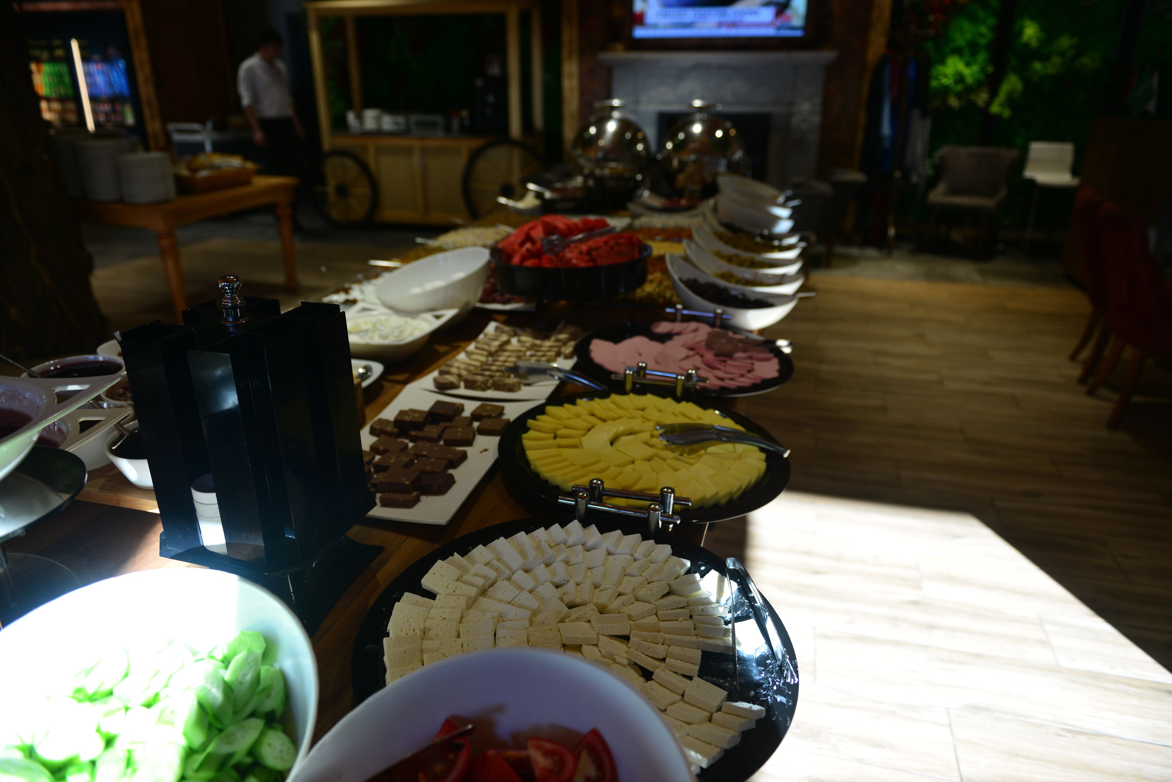 A buffet table with various food items and a coffee machine.