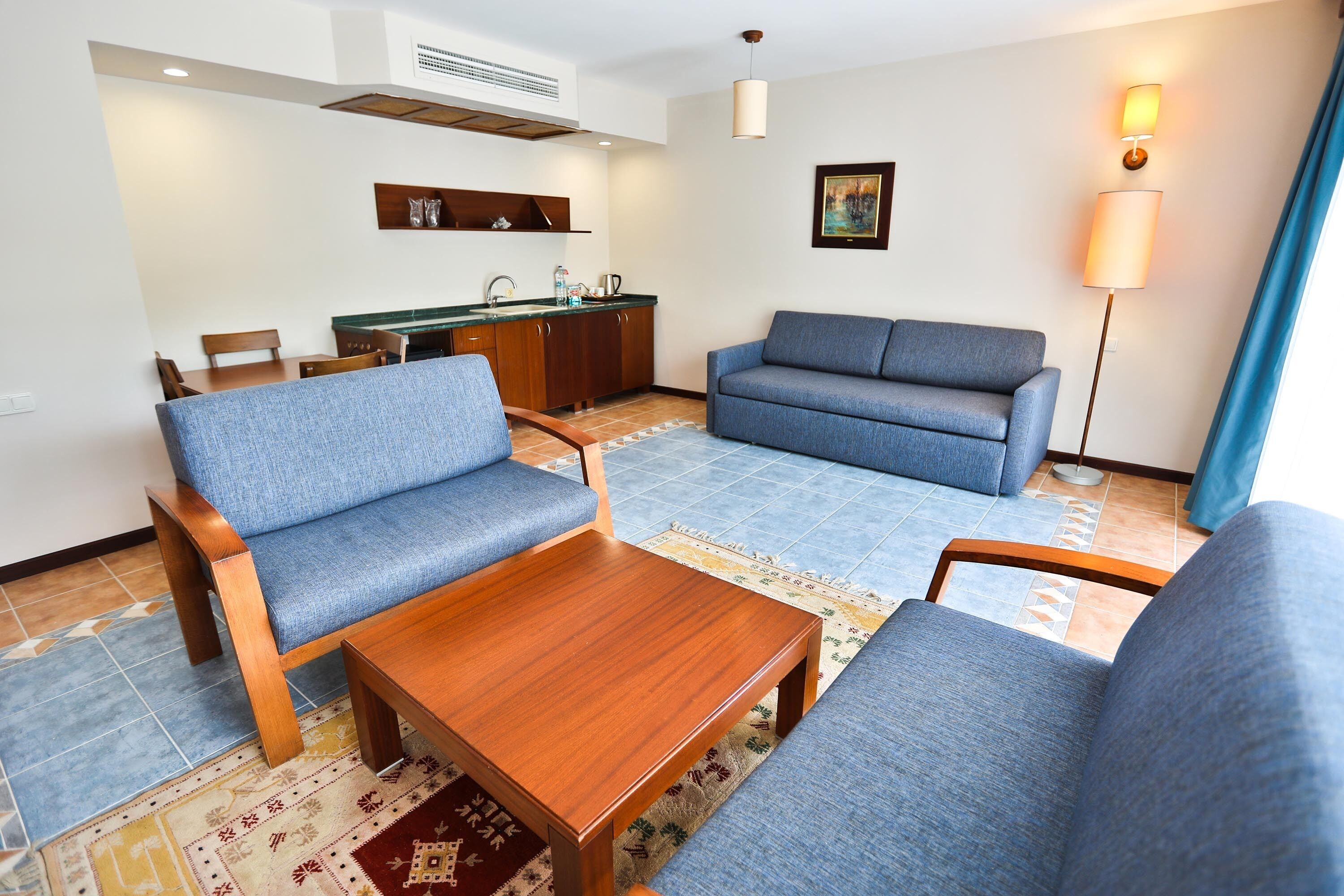 suite, 1 bedroom, garden area | living area | 83-cm lcd tv with cable channels, tv