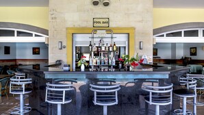 A bar area with a 'POOL BAR' sign, bar stools, and a variety of bottles. - Happy Hotel Kalkan (Kas)